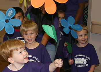 Children parading with paper flowers