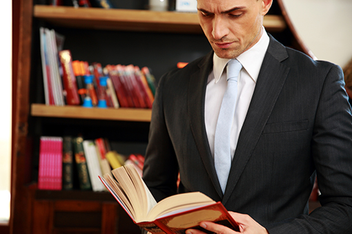 Paralegal reading a book in a library